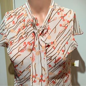 M❤️M. NWT.  Cream top with Orange/Yellow/Brown prints. Short sleeves.